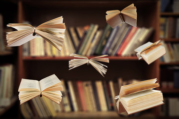 Flying open books in library