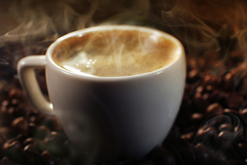 Cup of coffee and grains, closeup