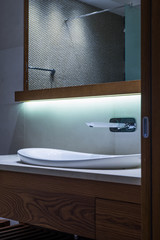 Lavatory and mirror in modern bathroom interior