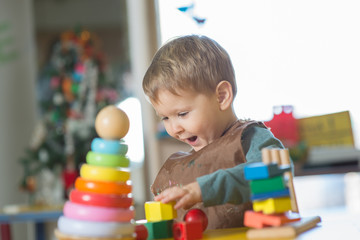 Fototapeta na wymiar Caucasian boy playing with toys