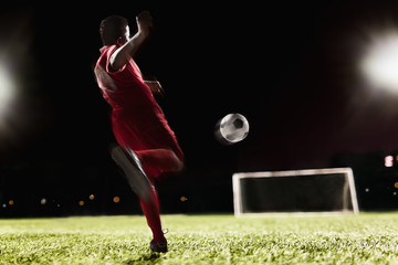 Soccer player kicking soccer ball