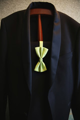 Grooms wedding suit with light green bow tie