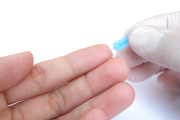 blue blood lancet penetrates to the skin of left hand 