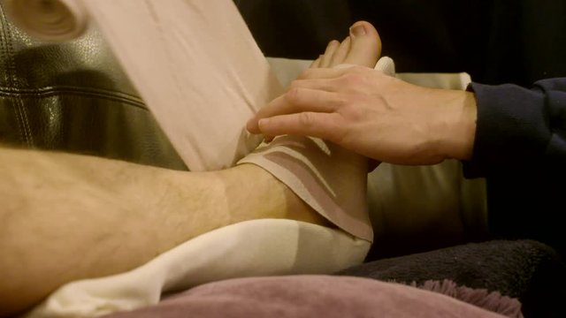 Physical Therapist Using Compression Wrap to Immobilize a Broken, Sprained, or Fractured Ankle