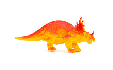 side view orange triceratops toy on a white background