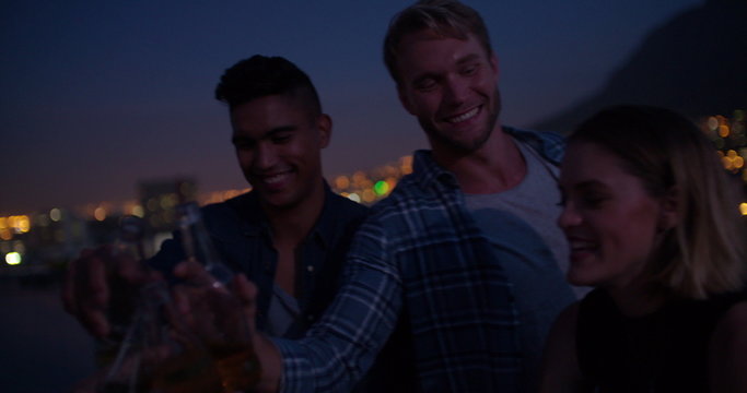 Young friends hanging out on the rooftop for a party