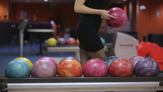 Woman takes bowling ball