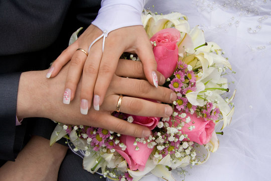 Hands of the bride and groom.