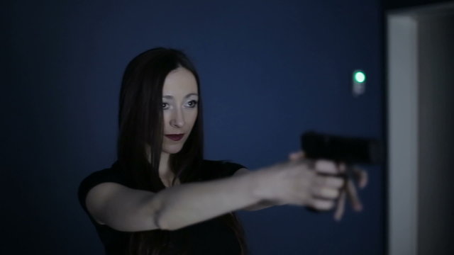 Firearms practice: Woman is shooting from laser gun