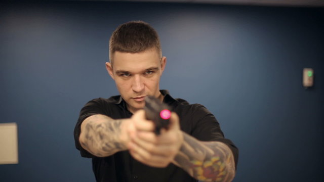 Firearms practice: Man is shooting from laser gun