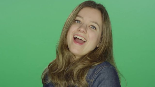 Young woman dancing, on a green screen studio background