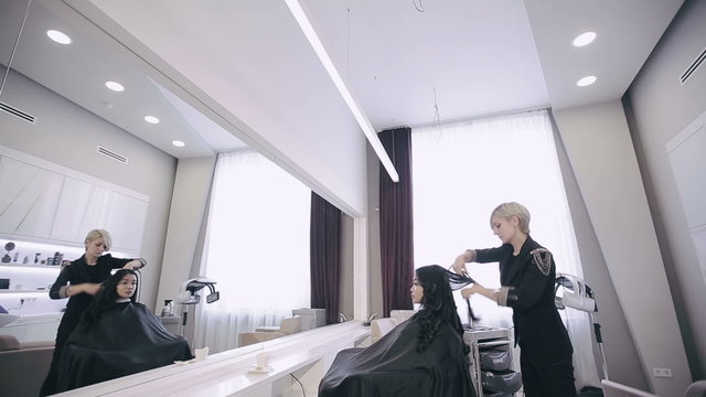 Attractive asian ethnicy girl have a curling procedure for her straight hair in a beauty shop