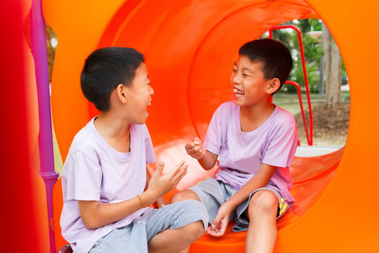 Twin boy laughing and playing.