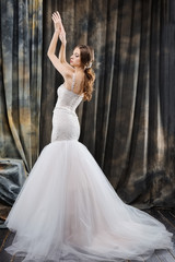 Fototapeta premium Attractive bride in wedding dress in studio