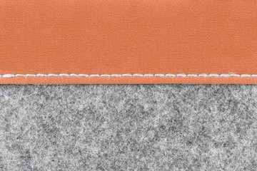 Gray fabric and brown leather background