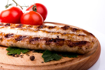 Grilled sausage with red hot pepper and tomatoes