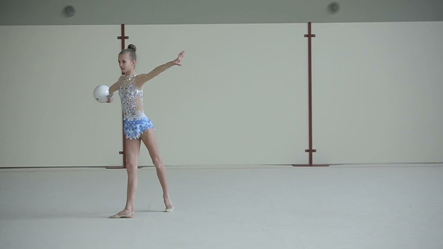 Rhythmic gymnastics: Teenager training a gymnastics exercise with a ball