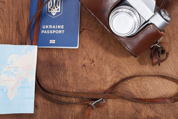 map, old camera and passport . Travel concept