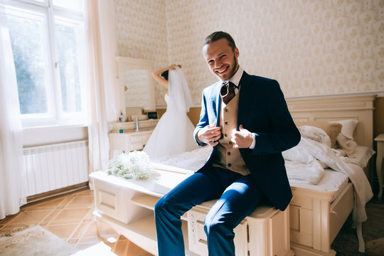 Groom portrait in bedroom at a wedding day. Wedding morning