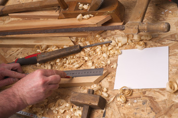 carpenter working,hammer,meter and screw-driver on construction background