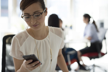 Female company employee looking at the smartphone