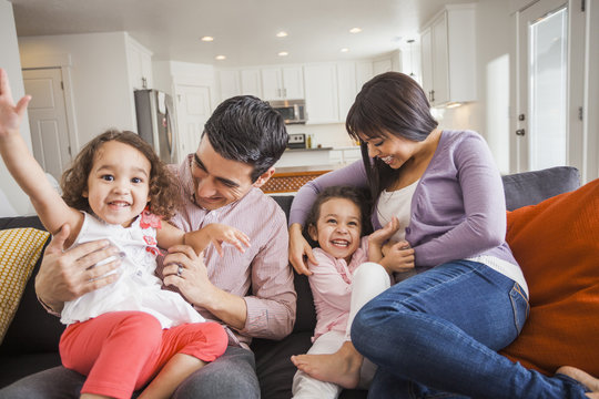 Family playing together on sofa