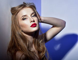 Beautiful woman with bright red lipstick. Long hair.