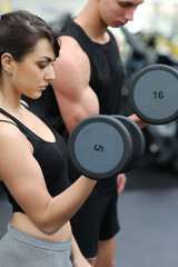 Muscular couple lifting dumbbells