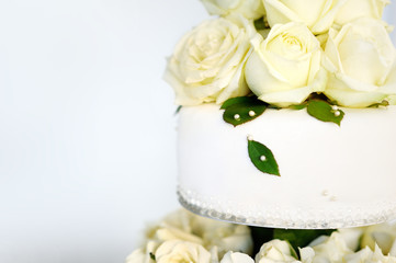 Delicious white wedding cake decorated with flowers