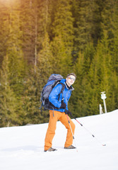 The man with the backpack.