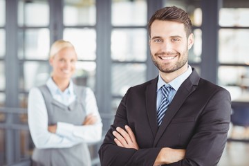 Happy businesman with colleague in background