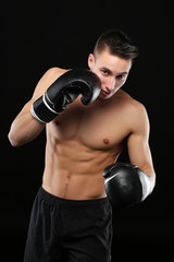 Fototapeta na wymiar Shirtless man with boxe gloves training