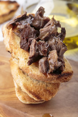 Peposo served over bruschetta.