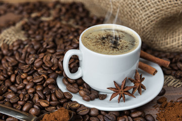 A cup of coffee and coffee beans