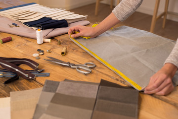Fashion designer measuring cloth