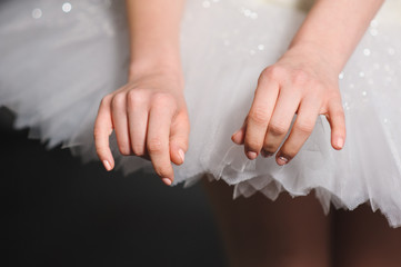 Hands of ballerinas with her tutu.