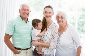 Smiling grandparents and mother with baby 