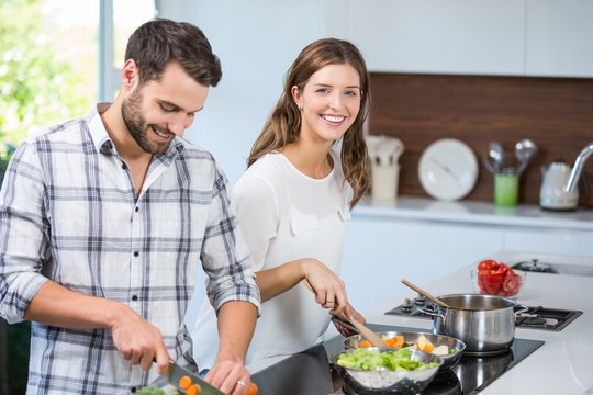Couple preparing food in kitchen at home