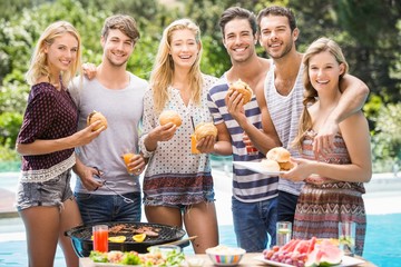 Group of friends having hamburgers and juice