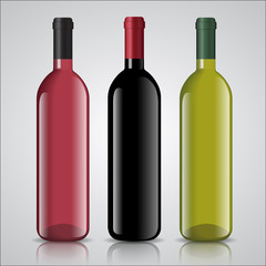 Three bottles of white and red wine with labels