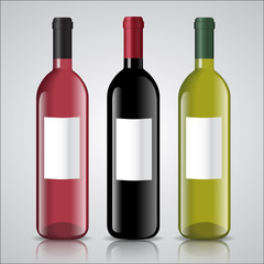 Three bottles of white and red wine with labels