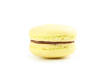 Tasty yellow macaron isolated on white