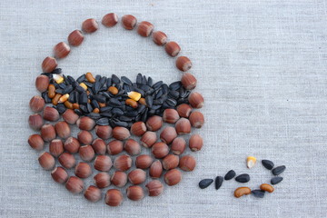 Basket laid of hazelnuts on flax