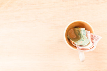 Money in glass ( Concept : Price of a drink  )