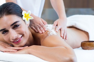 Obraz na płótnie Canvas Woman enjoying a salt scrub massage