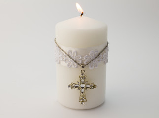 White candle with cross isolated on white background