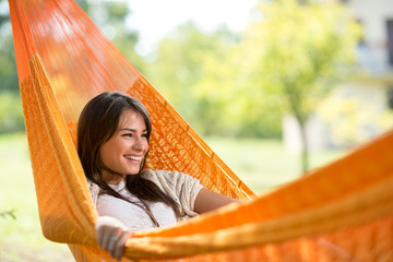 Smiling girl resting in hammock
