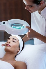 Masseuse looking at woman face