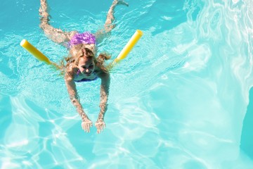 Woman swimming in swimming pool