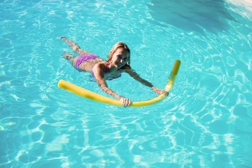 Woman swimming in swimming pool